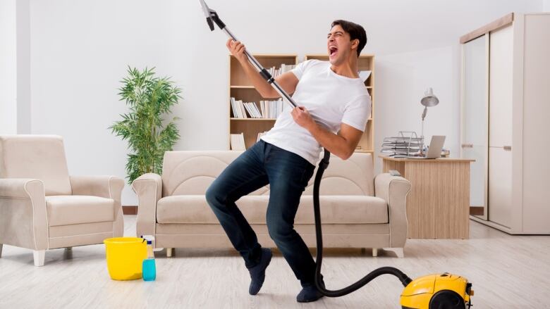 This image has an empty alt attribute; its file name is 519407452-man-happy-to-be-vacuuming.jpg