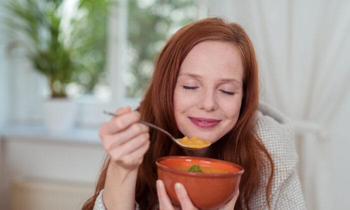 This image has an empty alt attribute; its file name is woman-eating-soup-700x420-1.jpg